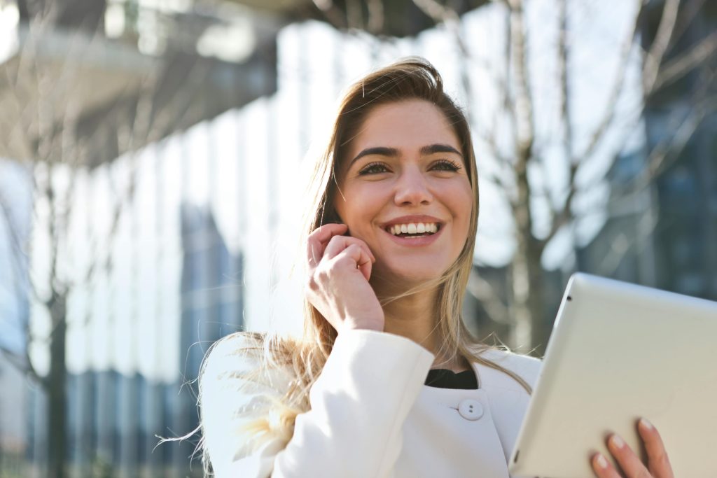 A woman on the phone asking her agent how much is the cost of starting a business.