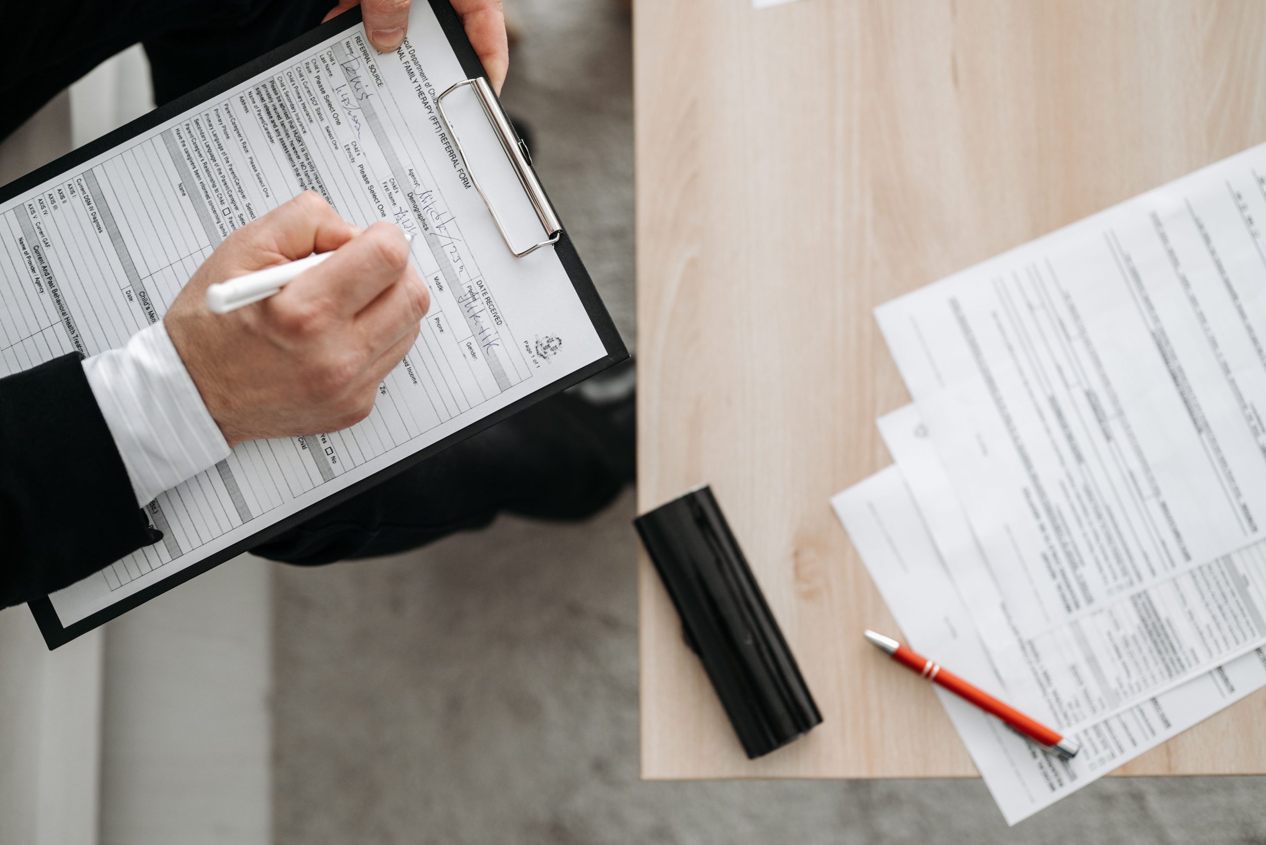 Business owner reviewing a calendar and paperwork at a desk